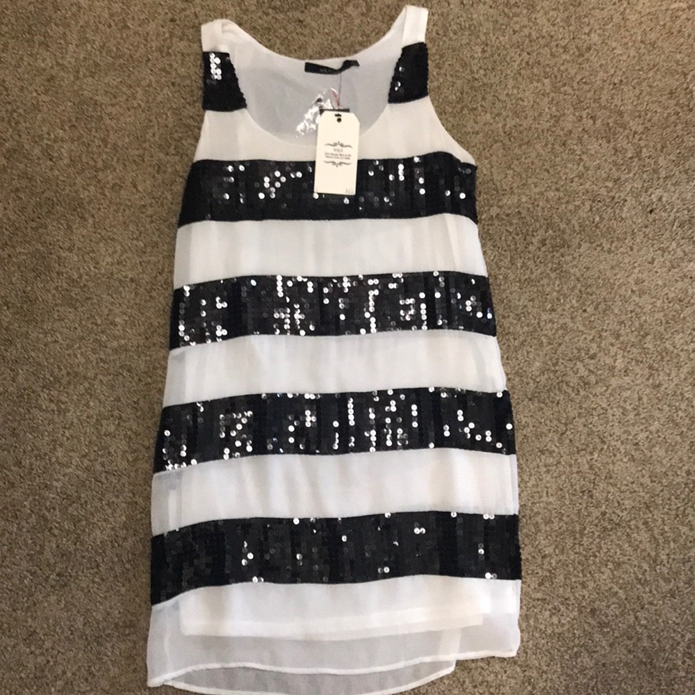 White with a black sequins dress.